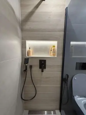 a bathroom with a shower with a sink and a toilet at Cozy design 1 bedroom apartment in Bansko