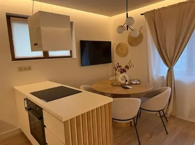 a kitchen and dining room with a table and chairs at Cozy design 1 bedroom apartment in Bansko