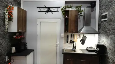 a small kitchen with a white door and a sink at Apartment Hangar 94 - Top Center - plus Free Vouchers in Sofia