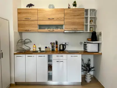 a kitchen with white cabinets and a counter at One-bedroom Apartment at Belvedere Holiday Club Complex in Bansko