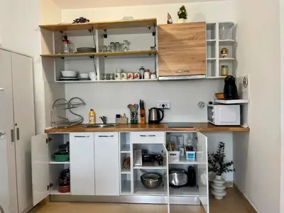 a kitchen with white cabinets and a counter at One-bedroom Apartment at Belvedere Holiday Club Complex in Bansko