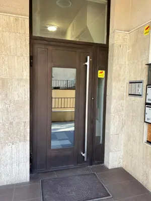a large wooden door on a building at The Mirror Apartment in Sofia