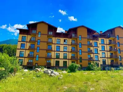 a large apartment building on top of a hill at CROWN Apartment Bansko in Bansko