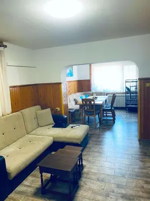 a living room with a couch and a table at Къща за гости Василеви in Bratsigovo