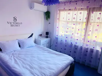 a bedroom with a white bed and a window at Къща за гости Василеви in Bratsigovo
