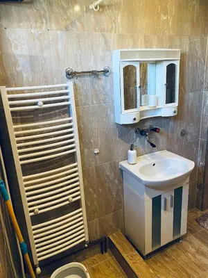 a bathroom with a sink and a mirror at Къща за гости Василеви in Bratsigovo