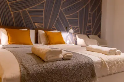 a bedroom with two beds with towels on them at Contemporary Vintage, 3BDR Grace Suite in Sofia