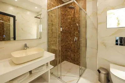 a bathroom with a sink and a shower at Lavalliere Hotel & Villas in Sarnitsa