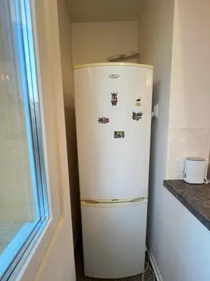a white refrigerator in a corner with magnets on it at Glasgow 2BDR peaceful Apt 1 min from Metro w WiFi in Sofia