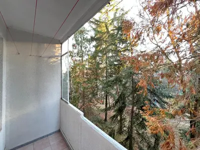 a balcony with a window looking out at a tree at Glasgow 2BDR peaceful Apt 1 min from Metro w WiFi in Sofia