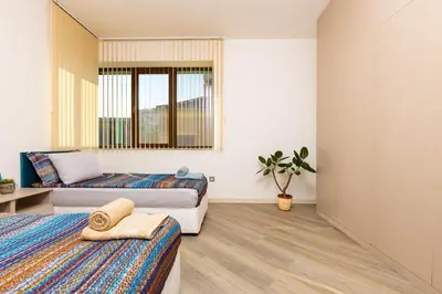 a bedroom with two beds and a mirror at Two bedroom apt Karavelov with Private Parking Medical University in Plovdiv
