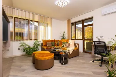 a living room with a couch and a table at Two bedroom apt Karavelov with Private Parking Medical University in Plovdiv