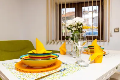 a table with colorful plates and bowls on it at Tiny Secret Place next to MU with Private Parking in Plovdiv