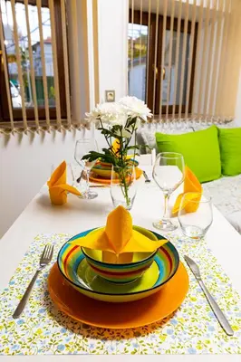 a table with a yellow plate and a yellow hat on it at Tiny Secret Place next to MU with Private Parking in Plovdiv
