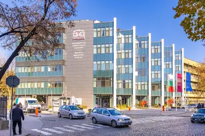 a building with cars parked in front of it at Tiny Secret Place next to MU with Private Parking in Plovdiv