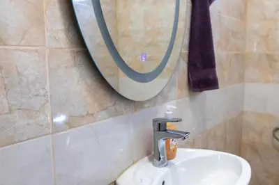 a bathroom with a sink and a mirror on the wall at Къща за гости Дар in Batak