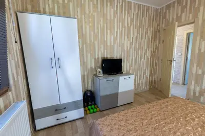a room with a large white cabinet and a television at Къща за гости Дар in Batak