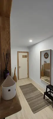 a living room with a large mirror on the wall at Leaf apartment in Blagoevgrad