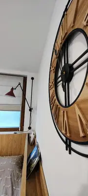 a large clock on the side of a wall at Leaf apartment in Blagoevgrad