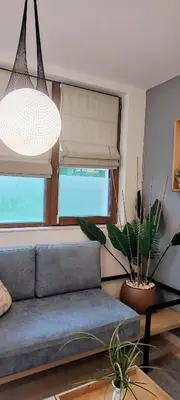 a living room with a couch and a window at Leaf apartment in Blagoevgrad