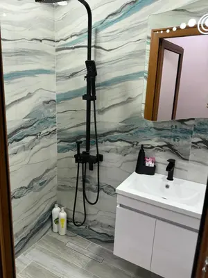 a bathroom with a shower and a sink at Патилови in Sandanski