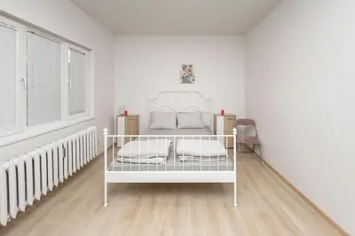 a bedroom with a white bed in a white room at Sofia Center - Vitoshka apartment in Sofia