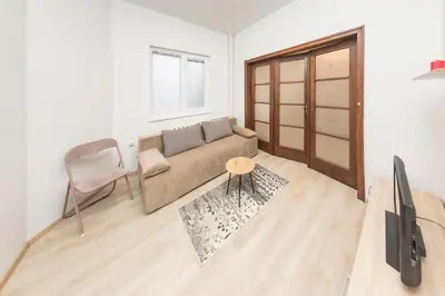 a living room with a couch and a tv at Sofia Center - Vitoshka apartment in Sofia