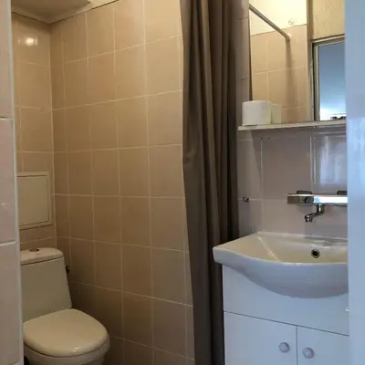 a bathroom with a sink and a toilet and a mirror at Rooftop Central Studio in Sofia