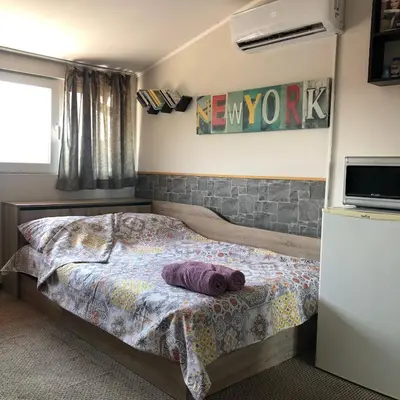 a bedroom with a bed with a pillow on it at Rooftop Central Studio in Sofia