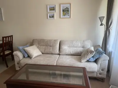 a living room with a couch and a glass table at Ski Lift - NoVi Apartments Bansko in Bansko