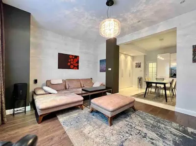 a living room with a couch and a table at Perfectly Sumptuous Centre Apartment, 2-minute walk from Vitosha Boulevard in Sofia