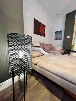 a living room with a couch and a chair at Perfectly Sumptuous Centre Apartment, 2-minute walk from Vitosha Boulevard in Sofia