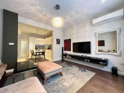 a living room with a television and a dining room at Perfectly Sumptuous Centre Apartment, 2-minute walk from Vitosha Boulevard in Sofia