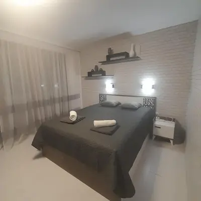a bedroom with a bed with two towels on it at lux apartament 88 in Bansko