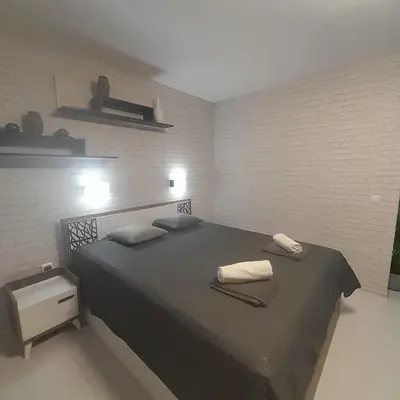 a bedroom with a bed with two towels on it at lux apartament 88 in Bansko