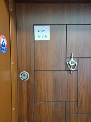 a wooden door with a sign on it at South Park apartment free parking near Tokuda in Sofia