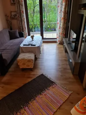 a living room with a couch and a coffee table at South Park apartment free parking near Tokuda in Sofia