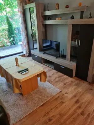 a living room with a coffee table and a tv at South Park apartment free parking near Tokuda in Sofia