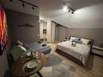 a bedroom with two beds and a table in it at Mountain studio ASP E63 Borovets Gardens in Borovets