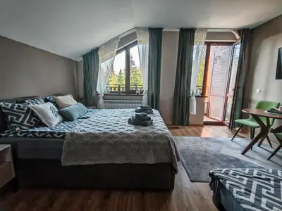 a bedroom with a bed and a large window at Mountain studio ASP E63 Borovets Gardens in Borovets
