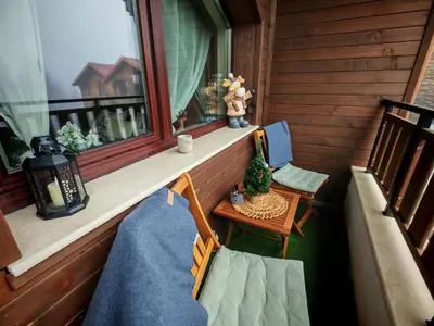 a balcony with a table and chairs and a window at Mountain studio ASP E63 Borovets Gardens in Borovets