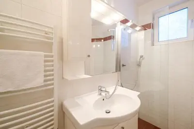 a white bathroom with a sink and a mirror at The Hill House Free Parking in Plovdiv
