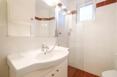 a white bathroom with a sink and a mirror at The Hill House Free Parking in Plovdiv