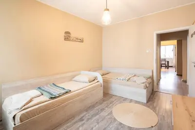 a living room with two couches and a table at Megan apartment Sofia Mall center in Sofia