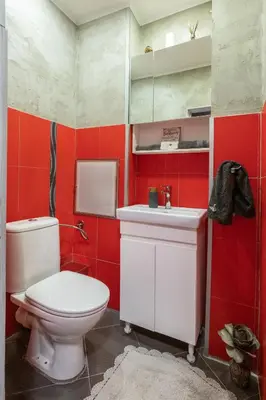 a red bathroom with a toilet and a sink at Megan apartment Sofia Mall center in Sofia