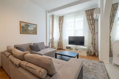 a living room with a couch and a flat screen tv at Aristocratic Elegant 2 BDRM spacious home TOP CENTER in Sofia