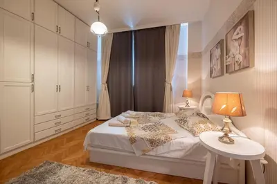 a bedroom with a bed and a table with a lamp at Aristocratic Elegant 2 BDRM spacious home TOP CENTER in Sofia