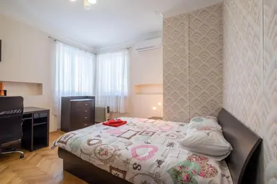 a bedroom with a bed and a desk and a television at Very Central & Aristocratic 2 Bedroom Apartment with Air conditioning in Sofia