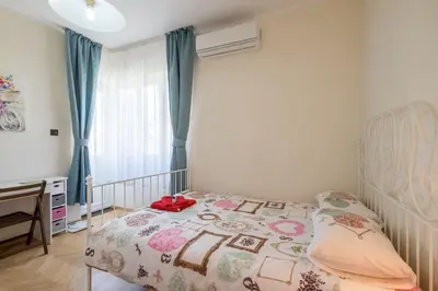 a bedroom with a bed and a desk in it at Very Central & Aristocratic 2 Bedroom Apartment with Air conditioning in Sofia