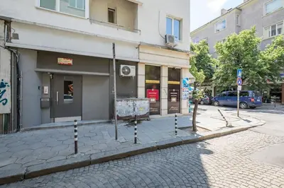a building on a street with poles on the sidewalk at Very Central & Aristocratic 2 Bedroom Apartment with Air conditioning in Sofia